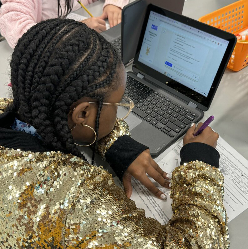 computer icon with play button on blue background with text: student spotlight