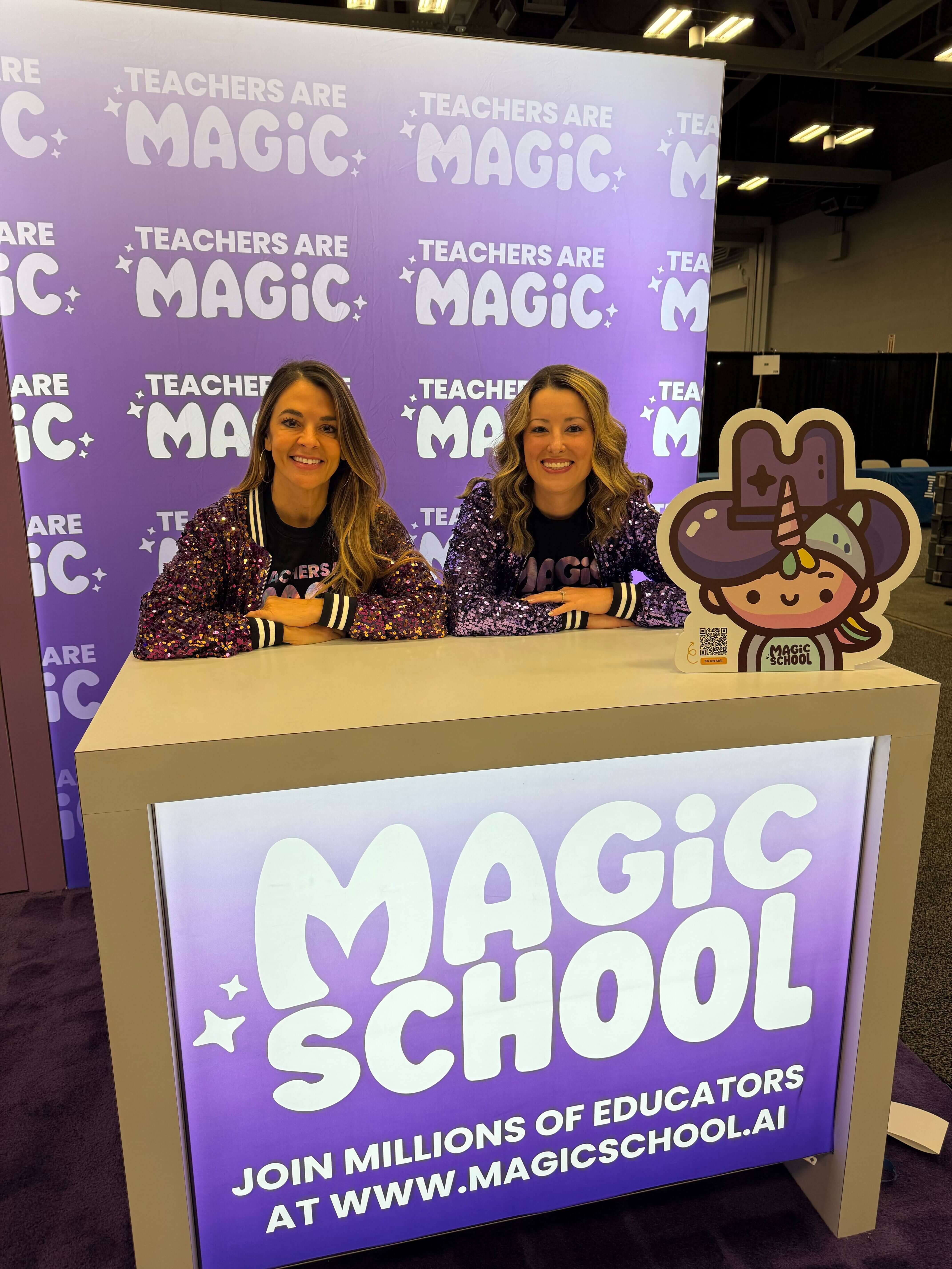 2 MagicSchool employees in sparkly purple jackets at a MagicSchool booth at a conference